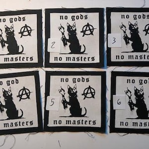 May include: Six square fabric patches featuring a black cat holding a flaming bottle, an anarchy symbol, and the text no gods no masters. Each patch is numbered one through six on a small white tag attached to the front of the fabric design.