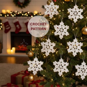 May include: A decorated Christmas tree featuring white crochet snowflake ornaments. The snowflake decorations are suspended from the tree branches. The image includes the text "CROCHET PATTERN". The tree is adorned with gold baubles and fairy lights.
