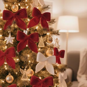 May include: A decorated Christmas tree with red and white knitted bows, gold ornaments, star and angel decorations, and warm white lights. The tree is in a cozy, well-lit room.