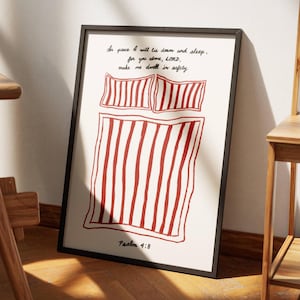 May include: A framed print with a red and white striped illustration of a bed and the text "In peace I will lie down and sleep, for you alone, LORD, make me dwell in safety. Psalm 4:8"