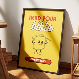 May include: A yellow poster with black text that reads "Read your bible everyday". The poster features a cartoon illustration of a bible with a smiling face and arms and legs.