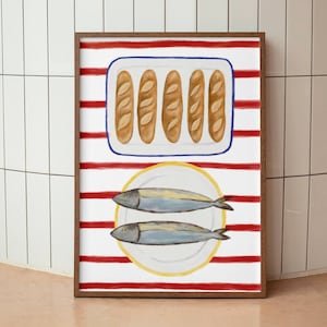 May include: A framed print with watercolour illustrations of food. The top section shows five baguettes in a rectangular dish. The bottom section displays two fish on a plate. The background has red and white stripes.