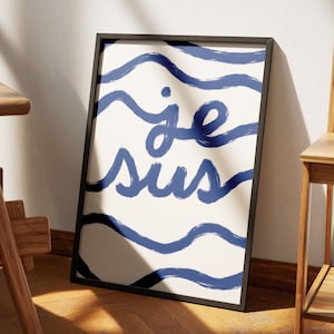 May include: A framed print with a white background and blue wavy lines. The text "je suis" is written in blue cursive.