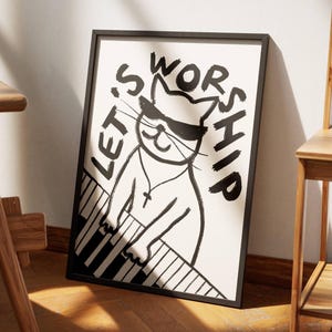 May include: Black and white illustration of a cat wearing sunglasses playing a piano with the text "Let's Worship" written around it.