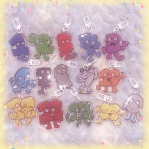 May include: A white ceramic mug with a black handle and the text "But First, Coffee" in a black, bold font. The mug is on a wooden surface. The mug is approximately 10 cm tall.