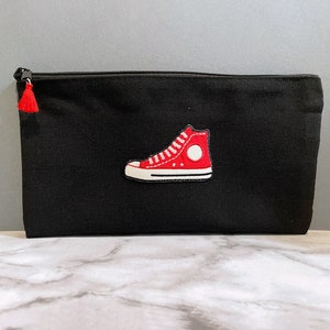 converse with pouch on back