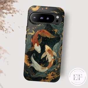 May include: A phone case with a dark blue background featuring two gold and orange koi fish swimming in a swirling pattern of gold and white lines. The case has a black border and a camera cutout.