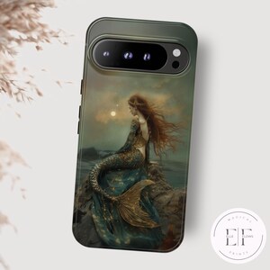 May include: A green phone case featuring a mermaid illustration. The artwork depicts a mermaid with long red hair, a blue and gold tail, and a flowing blue gown, seated on a rock near the sea under a moonlit sky. The case has a sleek design.
