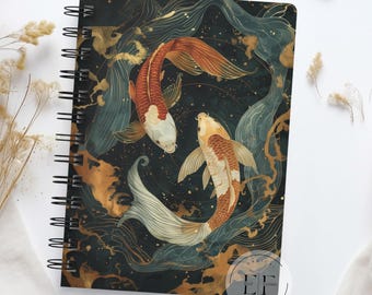 May include: A dark blue notebook cover with a gold and white design featuring two koi fish swimming in a swirling pattern. The cover has a spiral binding and the text "Eclectic Flows Prints" in white.