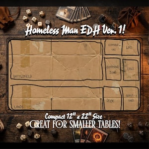 May include: A brown cardboard-style playmat for tabletop games, labeled "Homeless Man EDH Ver. 1!" with zones for Battlefield, Lands, and more. It measures 12" x 22" and is described as "Great for Smaller Tables!" Dice and cards surround the mat.