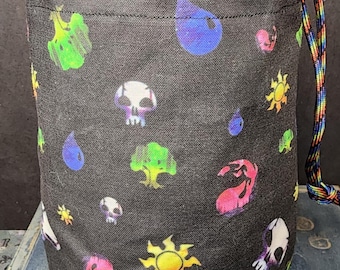 Puede incluir: Una bolsa cilíndrica de tela con cordón en color negro, con un patrón repetitivo de iconos coloridos que incluyen soles amarillos, gotas de agua azules, árboles verdes, llamas rosas y calaveras blancas. Incluye un cordón de colores arcoíris.