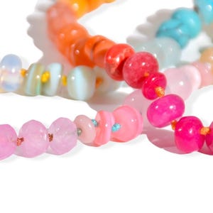 Candy Colored Long Beaded Gem Necklace featuring neon colored rainbow gemstones opal rainbow beads. 
 It is a beautiful Boho Chic Statement Necklace for the Summer in colors of bright neon pinks , purples, oranges, turquoise and yellows.