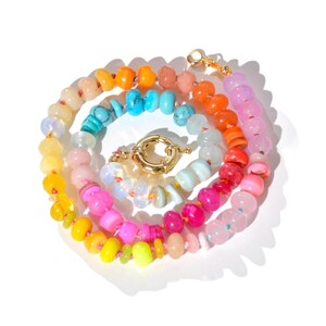 Candy Colored Long Beaded Gem Necklace featuring neon colored rainbow gemstones opal rainbow beads. 
 It is a beautiful Boho Chic Statement Necklace for the Summer in colors of bright neon pinks , purples, oranges, turquoise and yellows.