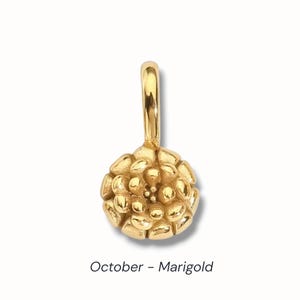 Gold birth flower charm representing each month, featuring a delicate embossed floral design on a round gold pendant — a personalized jewelry gift for her.