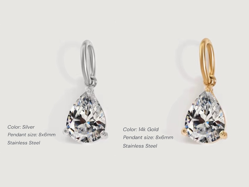 Gold diamond crystal charm displayed on a white background, each featuring a pear cut The clear faceted stones shimmer in the light, framed in gold settings with looped bails for attaching to necklaces or bracelets. Elegant minimalist photo showing jewelry-making pendants available in both gold and silver options.  Perfect for diy jewelry to use as add-on charms for any charm necklace or charm bracelet.