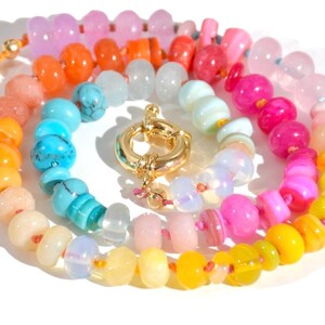 Candy Colored Long Beaded Gem Necklace featuring neon colored rainbow gemstones opal rainbow beads. 
 It is a beautiful Boho Chic Statement Necklace for the Summer in colors of bright neon pinks , purples, oranges, turquoise and yellows.