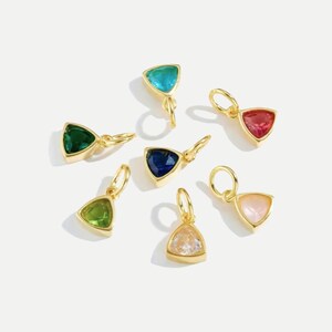 14k gold vermeil birthstone charms in a triangular bezel setting, each featuring a different colored gemstone, arranged neatly on a white background. Designed for necklaces and bracelets.