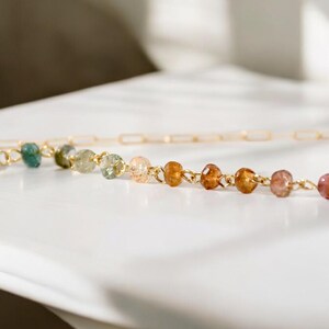 Gorgeous rainbow tourmaline rondelle beaded necklace that is wire wrapped toa 14k gold filled paperclip chain.  Handmade and handcrafted natural gems