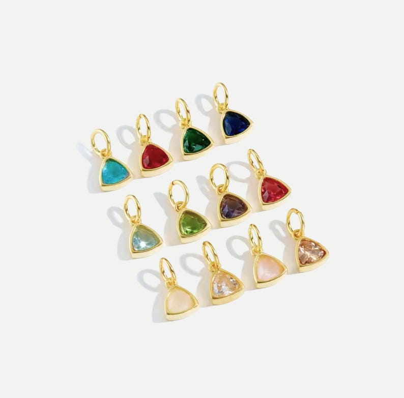 14k gold vermeil birthstone charms in a triangular bezel setting, each featuring a different colored gemstone, arranged neatly on a white background. Designed for necklaces and bracelets.