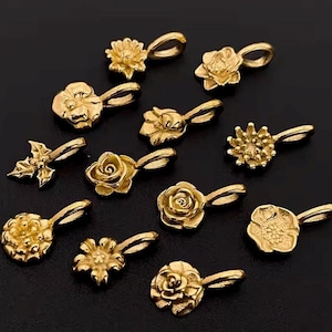 Gold birth flower charm representing each month, featuring a delicate embossed floral design on a round gold pendant — a personalized jewelry gift for her.