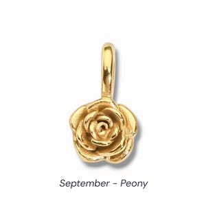 Gold birth flower charm representing each month, featuring a delicate embossed floral design on a round gold pendant — a personalized jewelry gift for her.