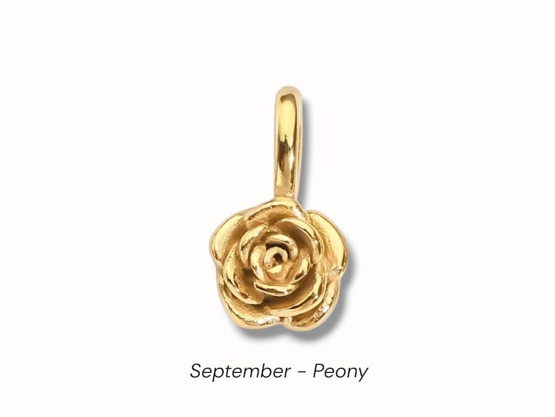 Gold birth flower charm representing each month, featuring a delicate embossed floral design on a round gold pendant — a personalized jewelry gift for her.