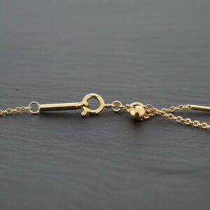 14k gold chain threader necklace with delicate bar needle. minimalist jewelry for her. close up of threader needle