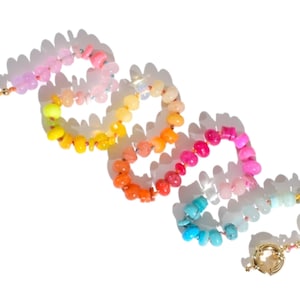 Candy Colored Long Beaded Gem Necklace featuring neon colored rainbow gemstones opal rainbow beads. 
 It is a beautiful Boho Chic Statement Necklace for the Summer in colors of bright neon pinks , purples, oranges, turquoise and yellows.