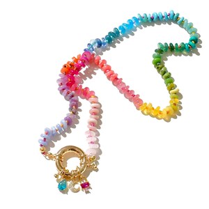 May include: A rainbow-colored beaded necklace with a gold clasp and charms. The beads are arranged in a gradient pattern, starting with blue and ending with yellow.