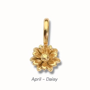 Gold birth flower charm representing each month, featuring a delicate embossed floral design on a round gold pendant — a personalized jewelry gift for her.