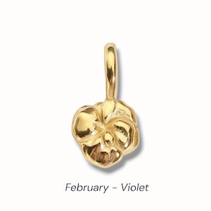 Gold birth flower charm representing each month, featuring a delicate embossed floral design on a round gold pendant — a personalized jewelry gift for her.