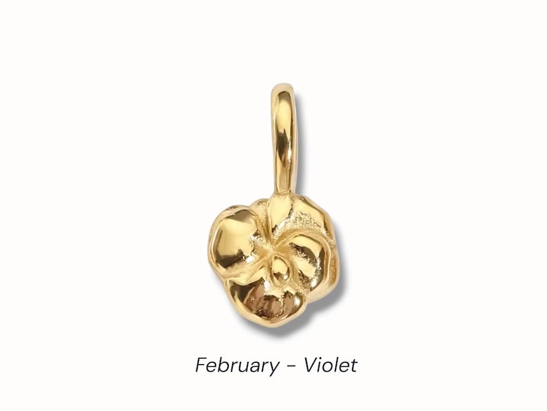 Gold birth flower charm representing each month, featuring a delicate embossed floral design on a round gold pendant — a personalized jewelry gift for her.