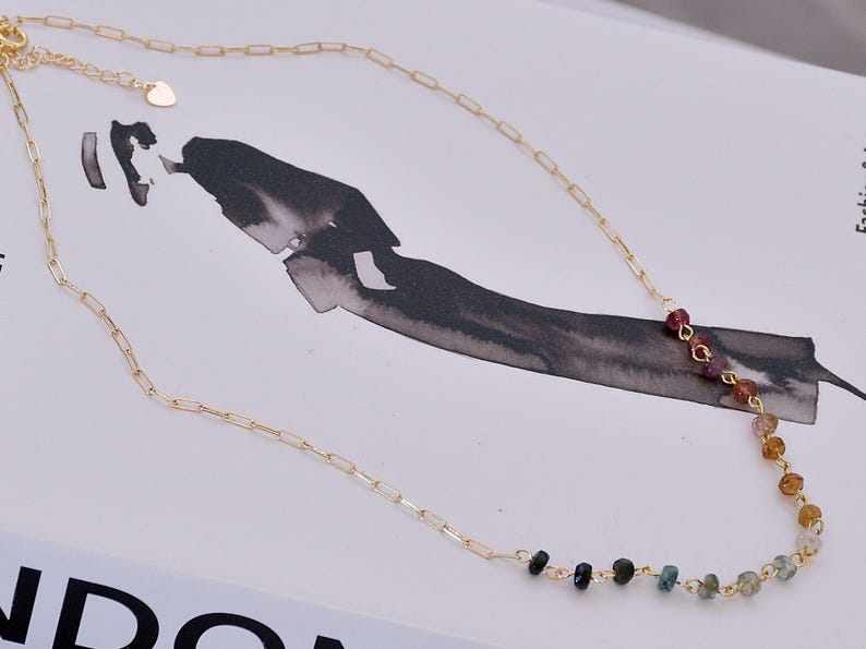 Gorgeous rainbow tourmaline rondelle beaded necklace that is wire wrapped toa 14k gold filled paperclip chain.  Handmade and handcrafted natural gems