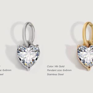 Gold diamond crystal charm displayed on a white background, each featuring a heart cut The clear faceted stones shimmer in the light, framed in gold settings with looped bails for attaching to necklaces or bracelets. Elegant minimalist photo showing jewelry-making pendants available in both gold and silver options.  Perfect for diy jewelry to use as add-on charms for any charm necklace or charm bracelet.