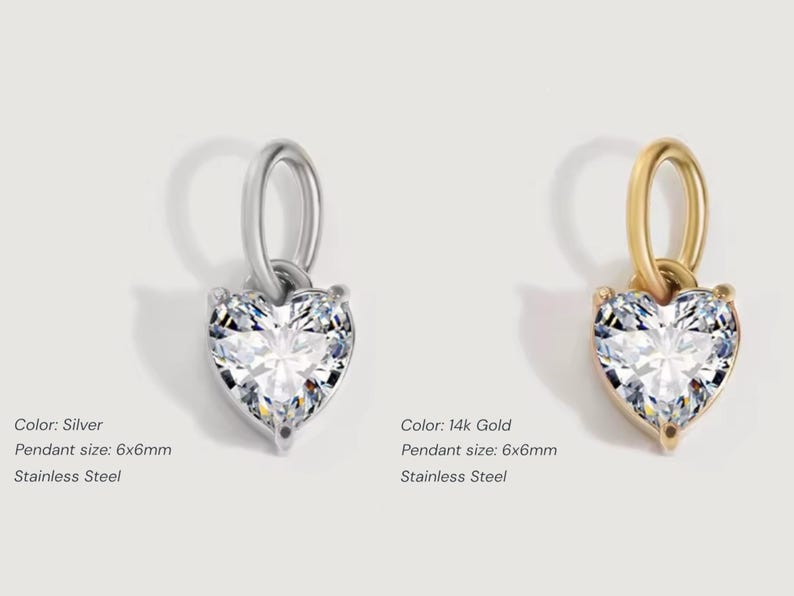 Gold diamond crystal charm displayed on a white background, each featuring a heart cut The clear faceted stones shimmer in the light, framed in gold settings with looped bails for attaching to necklaces or bracelets. Elegant minimalist photo showing jewelry-making pendants available in both gold and silver options.  Perfect for diy jewelry to use as add-on charms for any charm necklace or charm bracelet.