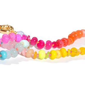Candy Colored Long Beaded Gem Necklace featuring neon colored rainbow gemstones opal rainbow beads. 
 It is a beautiful Boho Chic Statement Necklace for the Summer in colors of bright neon pinks , purples, oranges, turquoise and yellows.