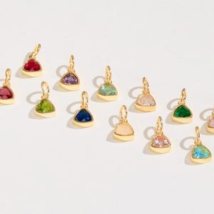 14k gold vermeil birthstone charms in a triangular bezel setting, each featuring a different colored gemstone, arranged neatly on a white background. Designed for necklaces and bracelets.