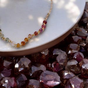 Gorgeous rainbow tourmaline rondelle beaded necklace that is wire wrapped toa 14k gold filled paperclip chain.  Handmade and handcrafted natural gems