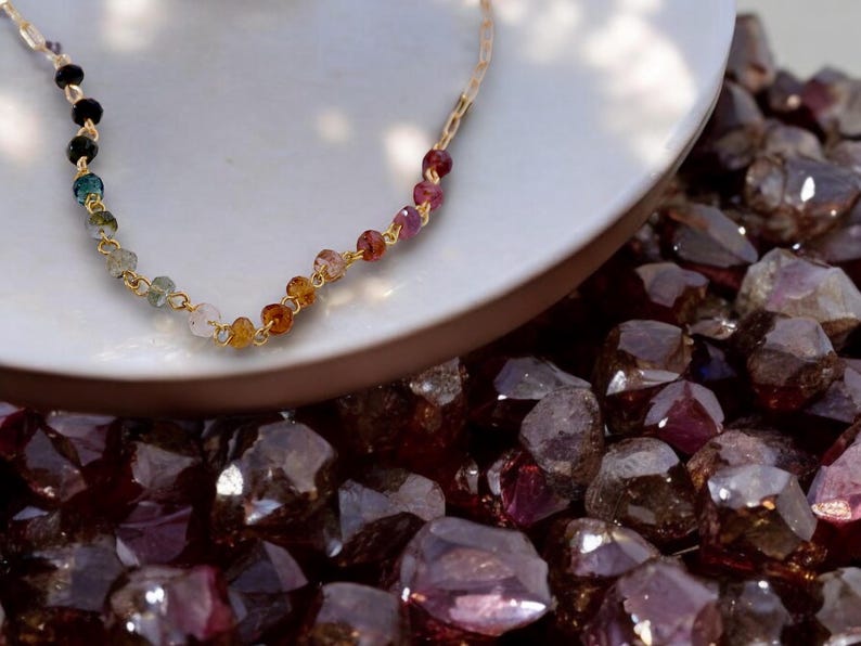 Gorgeous rainbow tourmaline rondelle beaded necklace that is wire wrapped toa 14k gold filled paperclip chain.  Handmade and handcrafted natural gems