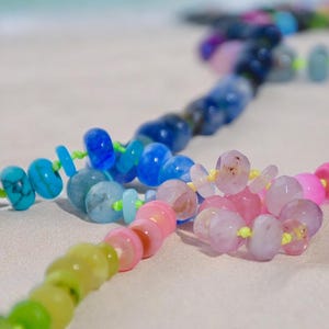 A rainbow multi-gemstone necklace that is handknotted   & handcrafted.  Made from natural semi precious gemstones.  This necklace is sure to add a pop of color to any outfit