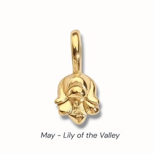 Gold birth flower charm representing each month, featuring a delicate embossed floral design on a round gold pendant — a personalized jewelry gift for her.