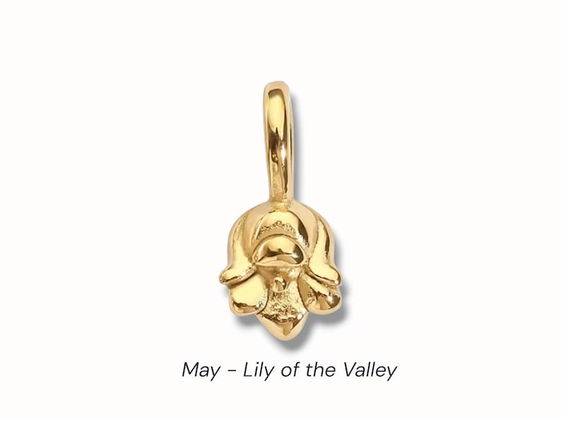 Gold birth flower charm representing each month, featuring a delicate embossed floral design on a round gold pendant — a personalized jewelry gift for her.