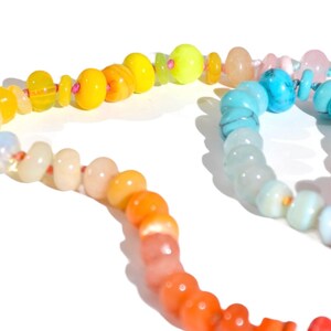 Candy Colored Long Beaded Gem Necklace featuring neon colored rainbow gemstones opal rainbow beads. 
 It is a beautiful Boho Chic Statement Necklace for the Summer in colors of bright neon pinks , purples, oranges, turquoise and yellows.