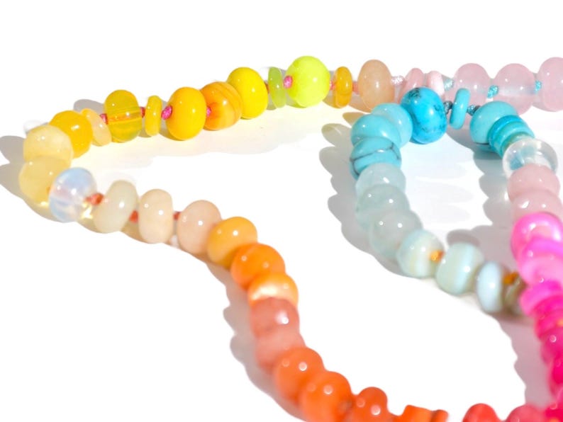Candy Colored Long Beaded Gem Necklace featuring neon colored rainbow gemstones opal rainbow beads. 
 It is a beautiful Boho Chic Statement Necklace for the Summer in colors of bright neon pinks , purples, oranges, turquoise and yellows.