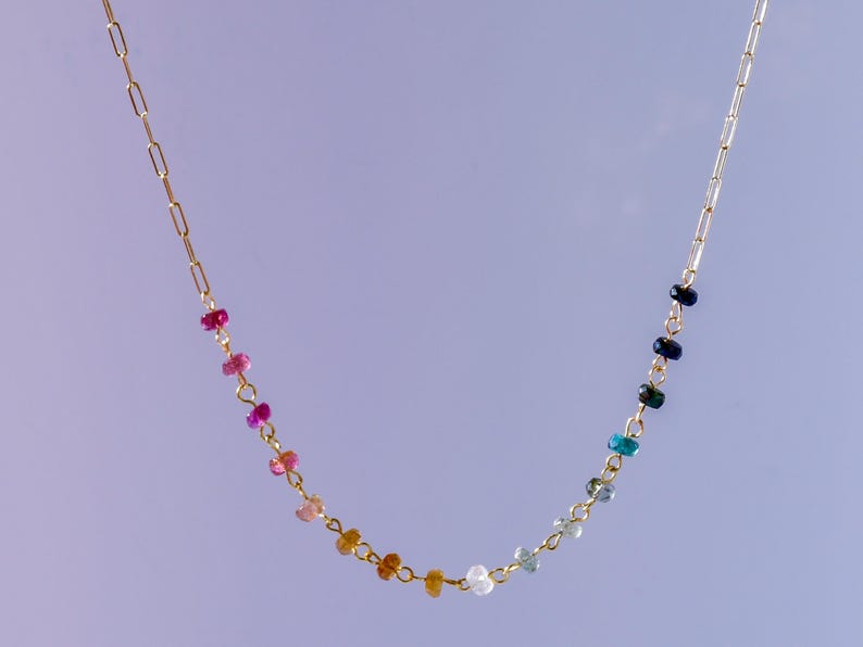 Gorgeous rainbow tourmaline rondelle beaded necklace that is wire wrapped toa 14k gold filled paperclip chain.  Handmade and handcrafted natural gems