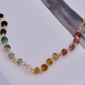 Gorgeous rainbow tourmaline rondelle beaded necklace that is wire wrapped toa 14k gold filled paperclip chain.  Handmade and handcrafted natural gems