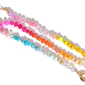 Candy Colored Long Beaded Gem Necklace featuring neon colored rainbow gemstones opal rainbow beads. 
 It is a beautiful Boho Chic Statement Necklace for the Summer in colors of bright neon pinks , purples, oranges, turquoise and yellows.