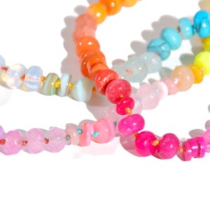 Candy Colored Long Beaded Gem Necklace featuring neon colored rainbow gemstones opal rainbow beads. 
 It is a beautiful Boho Chic Statement Necklace for the Summer in colors of bright neon pinks , purples, oranges, turquoise and yellows.