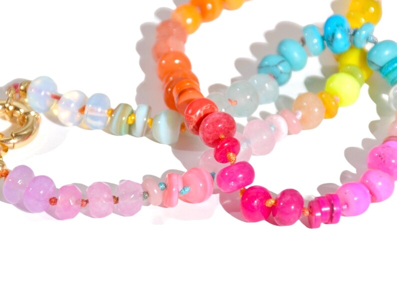 Candy Colored Long Beaded Gem Necklace featuring neon colored rainbow gemstones opal rainbow beads. 
 It is a beautiful Boho Chic Statement Necklace for the Summer in colors of bright neon pinks , purples, oranges, turquoise and yellows.