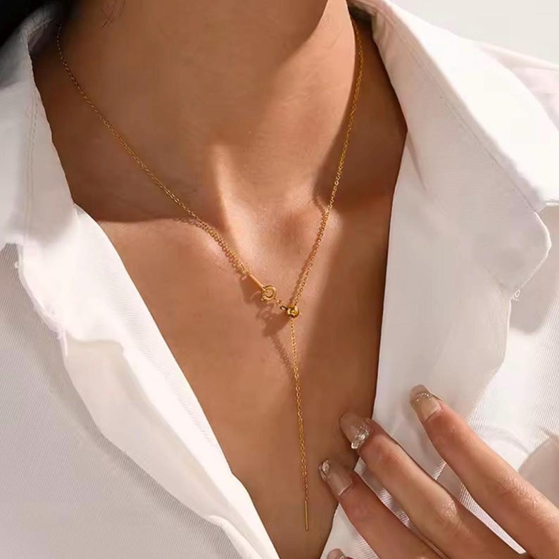 14k gold chain threader necklace with delicate bar needle. minimalist jewelry for her. model wearing the necklace